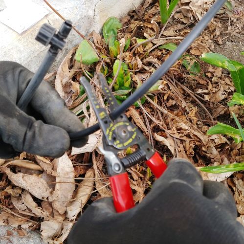 Using wire strippers to cut drip lines