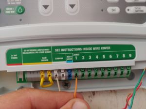 Close-up of wiring a replacement sprinkler timer